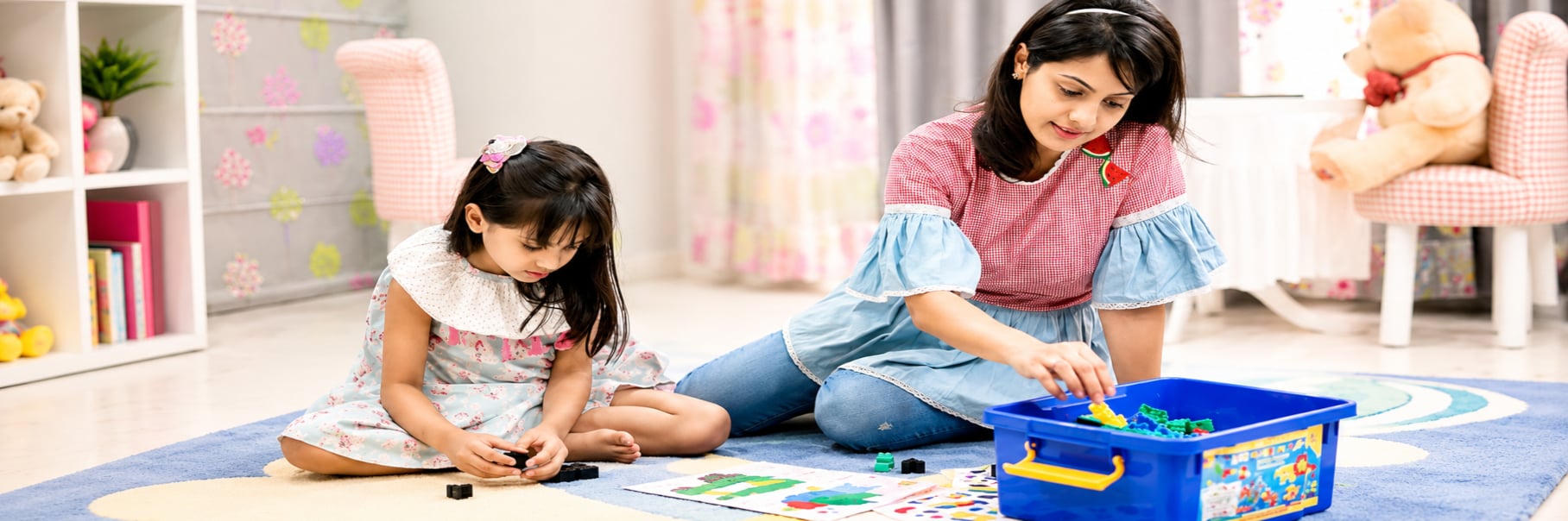 A child and mother playing together with GKL learning blocks